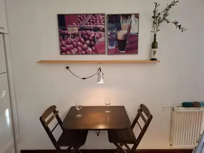a table with two chairs and a picture of apples at Antony's Elli beach home in Rhodes Town