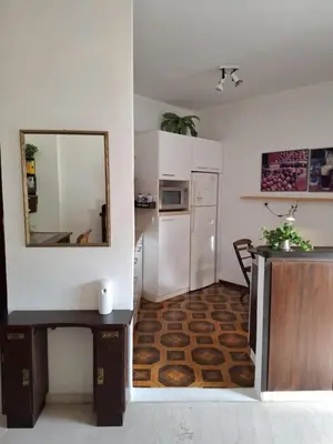 a kitchen with a table and a mirror and a refrigerator at Antony's Elli beach home in Rhodes Town