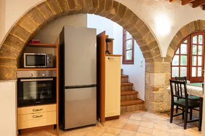a kitchen with an archway with a refrigerator at Harmonia - A Sanctuary in the Old Town of Rhodes in Rhodes Town
