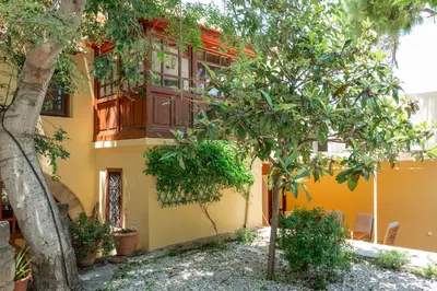 a house with a tree in front of it at Harmonia - A Sanctuary in the Old Town of Rhodes in Rhodes Town