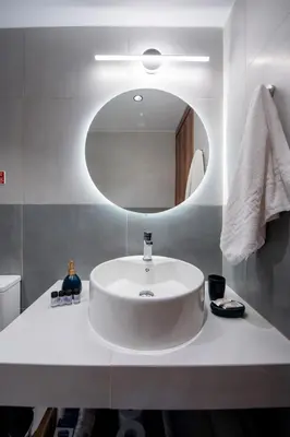 a bathroom with a white sink and a mirror at Dorothea Apartments #1 with sea view in Koskinou