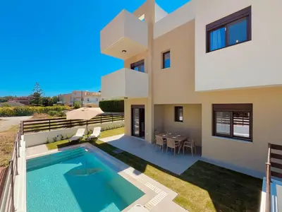 a villa with a swimming pool and a house at Villa Greige in Ialyssos