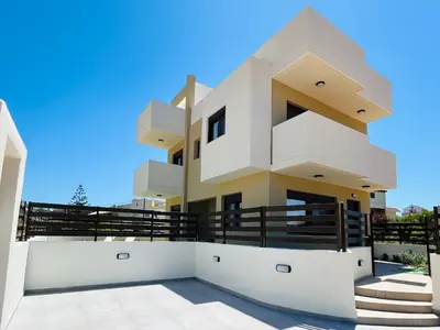 a building with a blue sky in the background at Villa Greige in Ialyssos