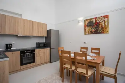 a kitchen with a table and chairs in a room at La Maison Antique in Rhodes Town