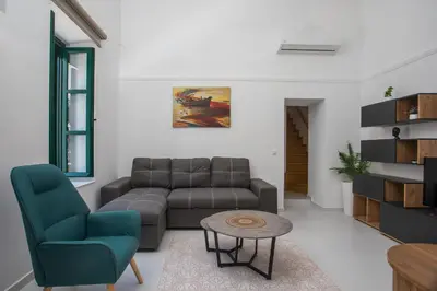 a living room with a couch and a table at La Maison Antique in Rhodes Town
