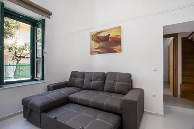 a living room with a couch and a window at La Maison Antique in Rhodes Town