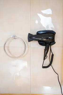 a black phone hanging on a wall at Angela's Green Escape in Triánta