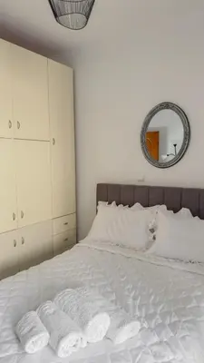 a bedroom with a white bed with two towels on it at Angela's Green Escape in Triánta
