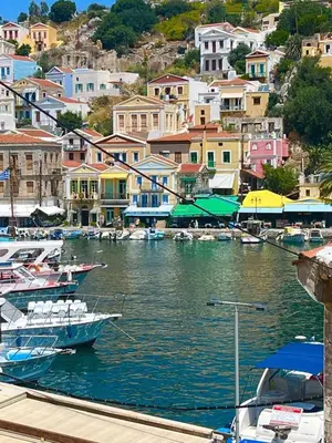 a group of boats are docked in a harbor at My Symi Apartments in Symi