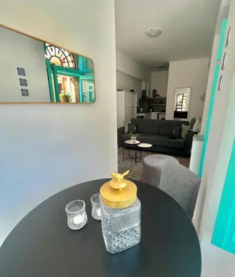 a living room with a table with a cake on it at My Symi Apartments in Symi