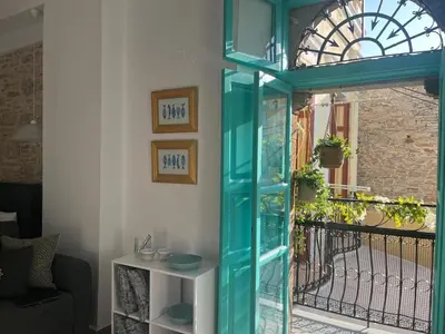 a blue glass door in front of a window at My Symi Apartments in Symi