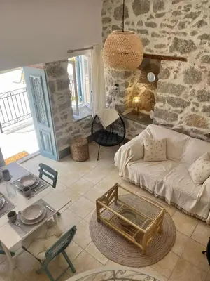 a living room with a couch and a table at Seaside House in Symi