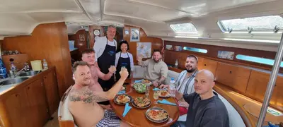 a group of people sitting around a table in a boat at Sailing Edisa Rhodes Adventures in Rhodes Town