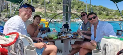 a group of people sitting at a table on a boat at Sailing Edisa Rhodes Adventures in Rhodes Town