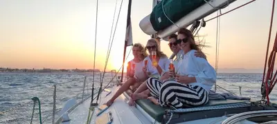 three women sitting on a sail boat in the water at Sailing Edisa Rhodes Adventures in Rhodes Town