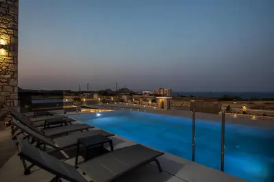 a swimming pool with lounge chairs on a roof at Blue Sunrise Villa 1 in Afantou