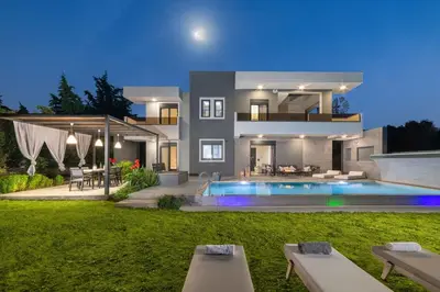 a large house with a swimming pool in the backyard at Harmony Villas Rhodes in Ialyssos