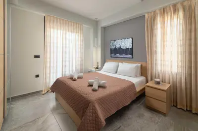 a bedroom with a bed with two teddy bears on it at Harmony Villas Rhodes in Ialyssos