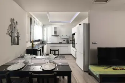 a dining room and kitchen with a table and chairs at Harmony Villas Rhodes in Ialyssos