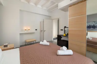 a bedroom with a bed with two towels on it at Harmony Villas Rhodes in Ialyssos