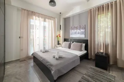 a bedroom with a bed and a large window at Harmony Villas Rhodes in Ialyssos