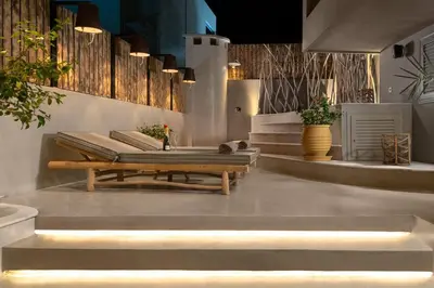 a patio with a bench and a table with lights at Elakati Luxury Boutique Hotel - Adults Only in Rhodes Town