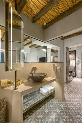 a bathroom with a sink and a large mirror at Elakati Luxury Boutique Hotel - Adults Only in Rhodes Town