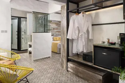 a hotel room with a robe hanging on a wall at Elakati Luxury Boutique Hotel - Adults Only in Rhodes Town