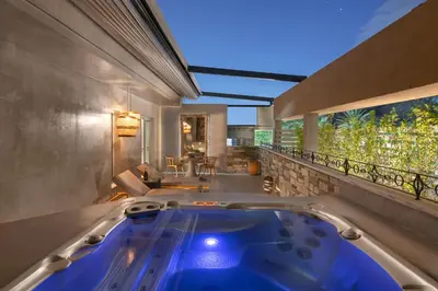 a jacuzzi tub in a room with a balcony at Elakati Luxury Boutique Hotel - Adults Only in Rhodes Town