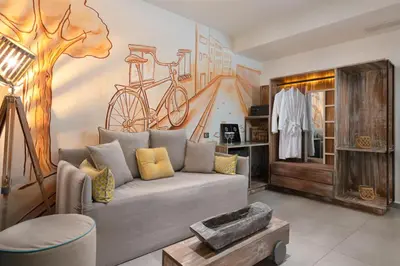 a living room with a couch and a bike mural at Elakati Luxury Boutique Hotel - Adults Only in Rhodes Town