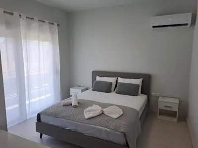 a bedroom with a bed with two towels on it at Giannis Apartment in Afantou