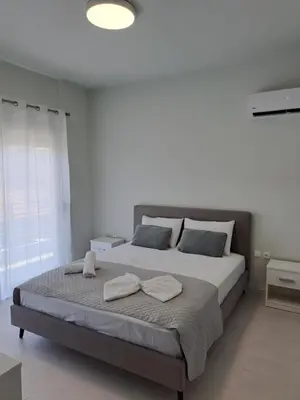 a bedroom with a large bed with two towels on it at Giannis Apartment in Afantou