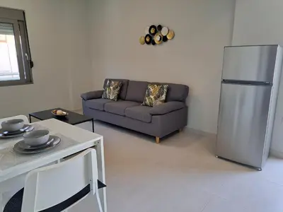 a living room with a couch and a refrigerator at Giannis Apartment in Afantou