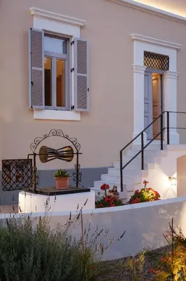 a white house with stairs and a bench at Aylin Executive Suites in Rhodes Town