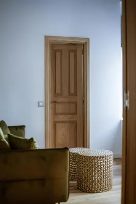 a living room with a couch and a table and a door at Aylin Executive Suites in Rhodes Town