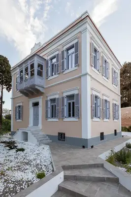 a house with a balcony on the side of it at Aylin Executive Suites in Rhodes Town