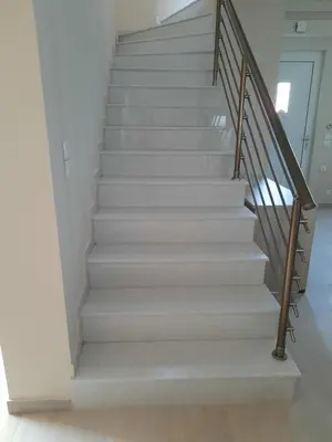 a stair case in a home with white stairs at Palm Marie - Rhodes in Kalithies