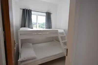 a white bunk bed in a room with a window at Sofia Villa Near Faliraki in Kalithies