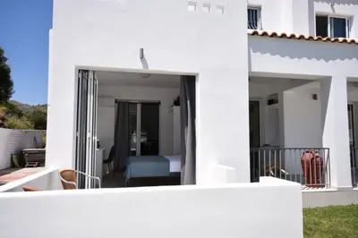 a white house with a bedroom and a balcony at Sofia Villa Near Faliraki in Kalithies