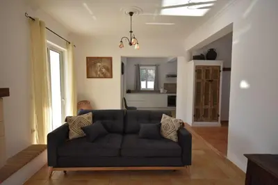 a living room with a black couch in a room at Sofia Villa Near Faliraki in Kalithies