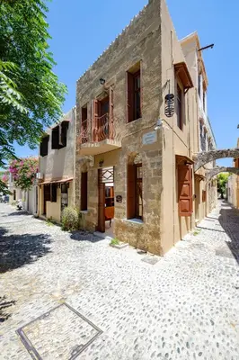 an old stone building on a cobblestone street at Kolonaki Corner in Rhodes Town