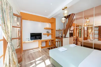 a bedroom with a bed and a tv in a room at Kolonaki Corner in Rhodes Town