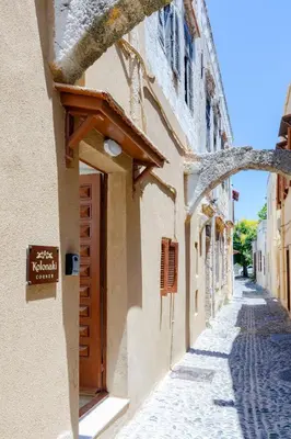 a building with a sign on the side of a street at Kolonaki Corner in Rhodes Town