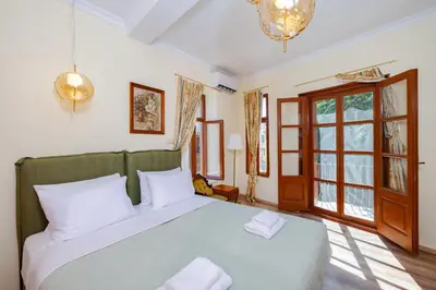 a bedroom with a large bed with white pillows at Kolonaki Corner in Rhodes Town