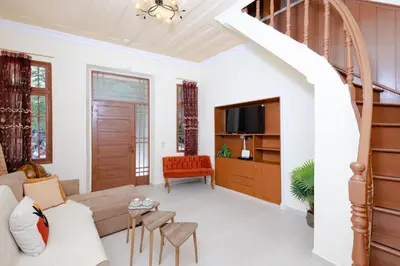 a living room with a couch and a tv at Kolonaki Corner in Rhodes Town