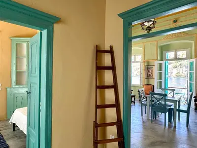 a room with a ladder and a room with a dining room at Lindiakos Villa AMI in Symi