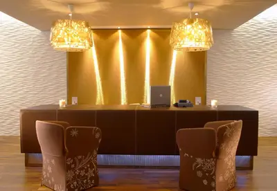 a table with two chairs and a laptop on it at Elysium Resort & Spa in Faliraki