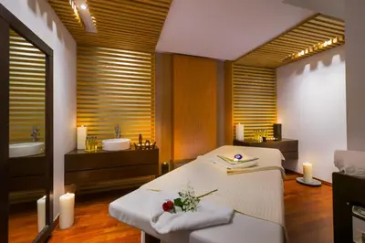a room with a bed and a bathroom with candles at Elysium Resort & Spa in Faliraki