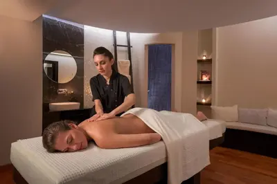 a woman laying on a bed in a massage room at Elysium Resort & Spa in Faliraki