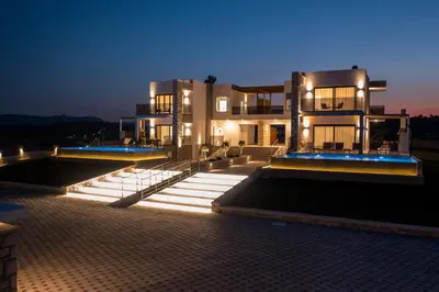 a large building at night with lights on it at Blue Sunrise Villa 2 in Afantou